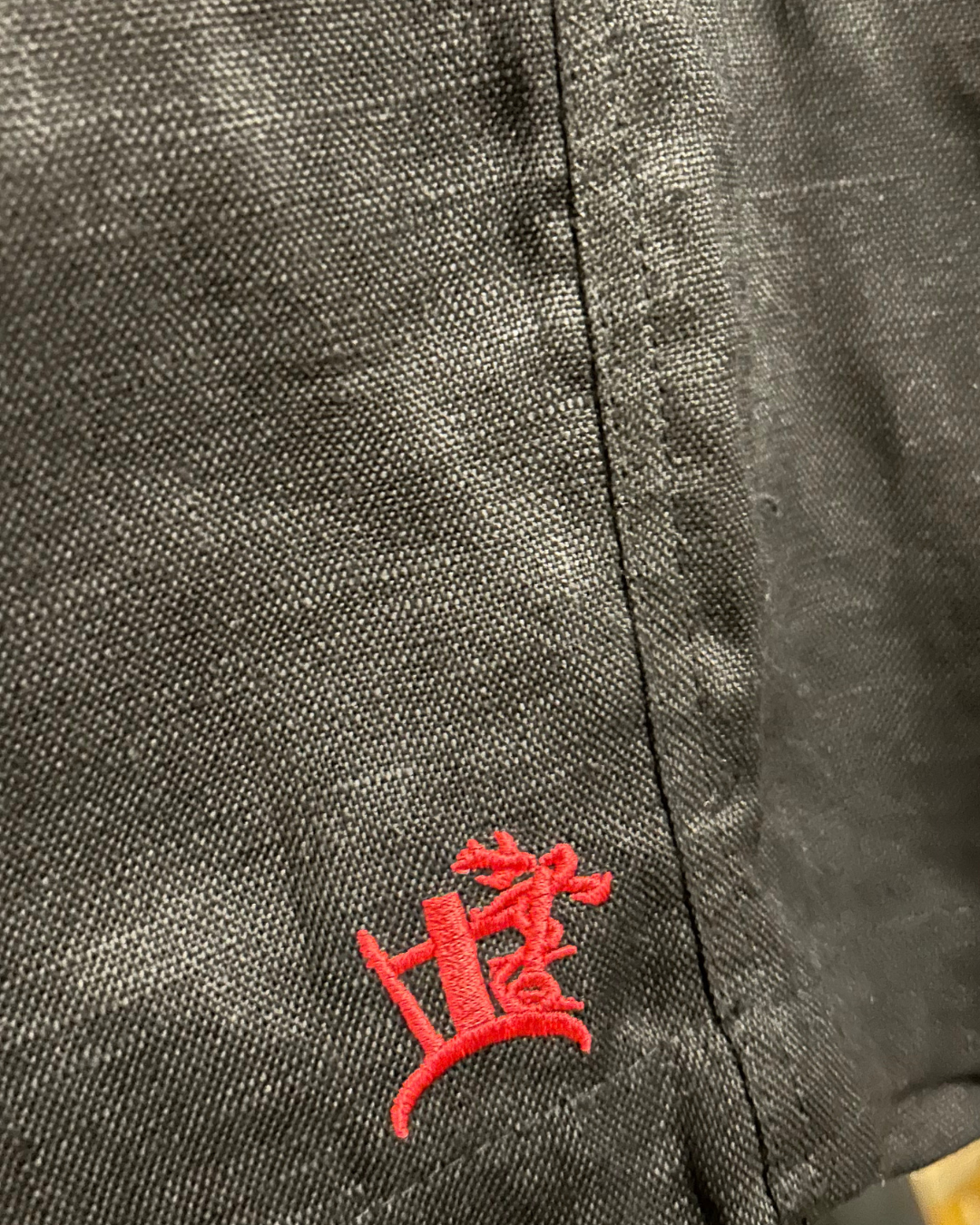 NERIA 100% LINEN SHORT BLACK CRIMSON CRUCIBLE LOGO